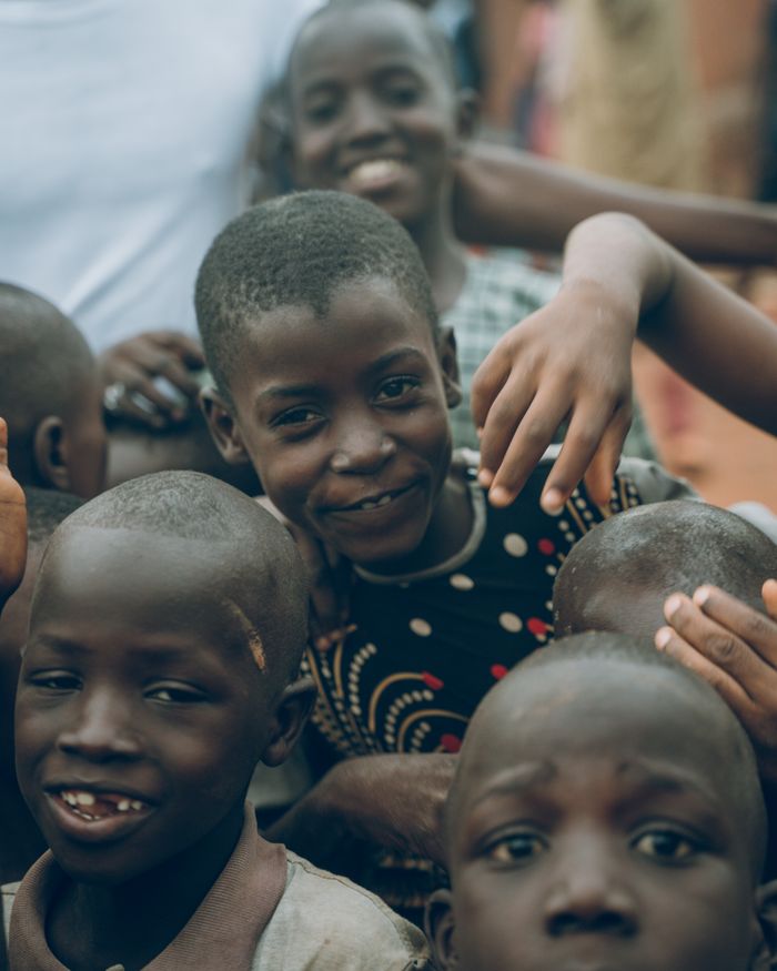 The Art of Drawing Readers In: Your attractive post title goes here Smiling Nigerian children joyfully gather, showcasing unity and happiness outdoors.